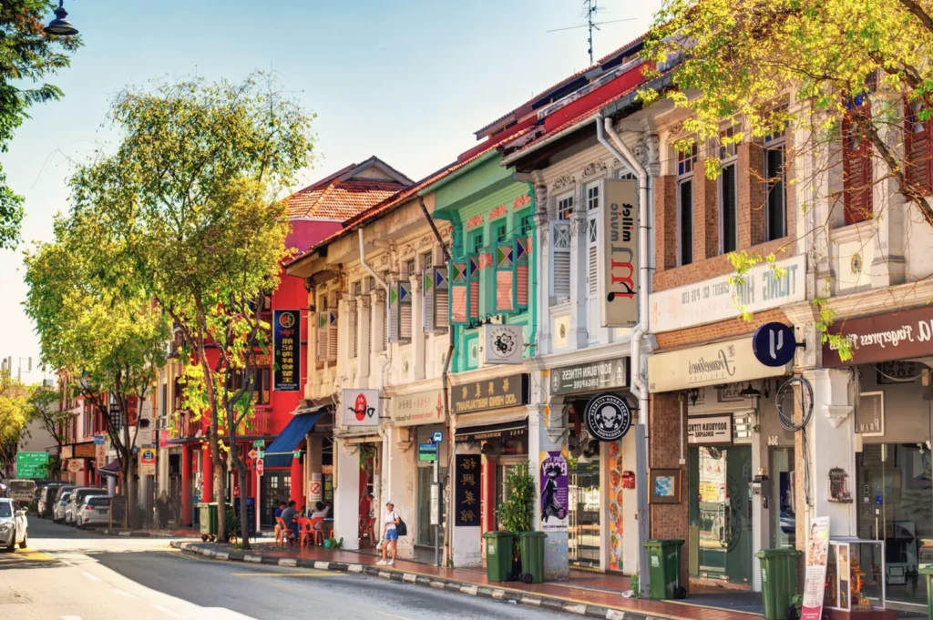 Colorful shophouses along Katong and Joo Chiat in Singapore — heritage architecture with cafés and boutiques under warm afternoon sunlight.
