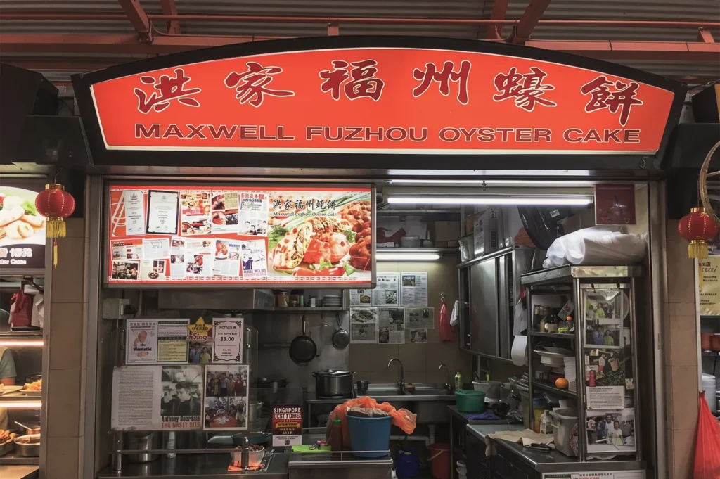 Maxwell Fuzhou Oyster Cake stall in Singapore showcasing crispy oyster cakes and media features, a must‑try local hawker delicacy.